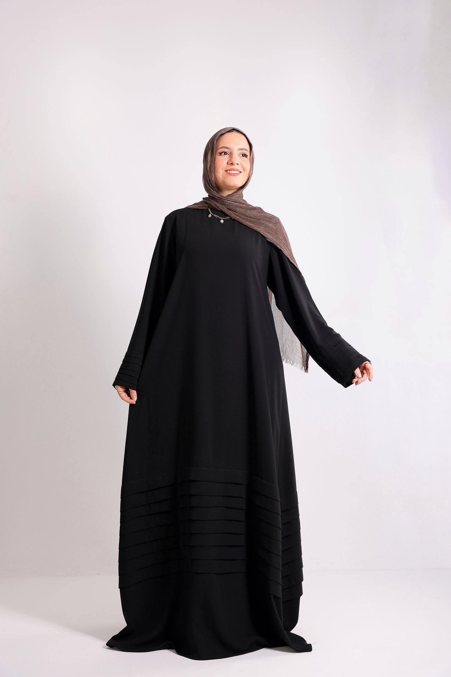 Soft crepe abaya with elegant pleated details on the sleeves and hem.Code 508