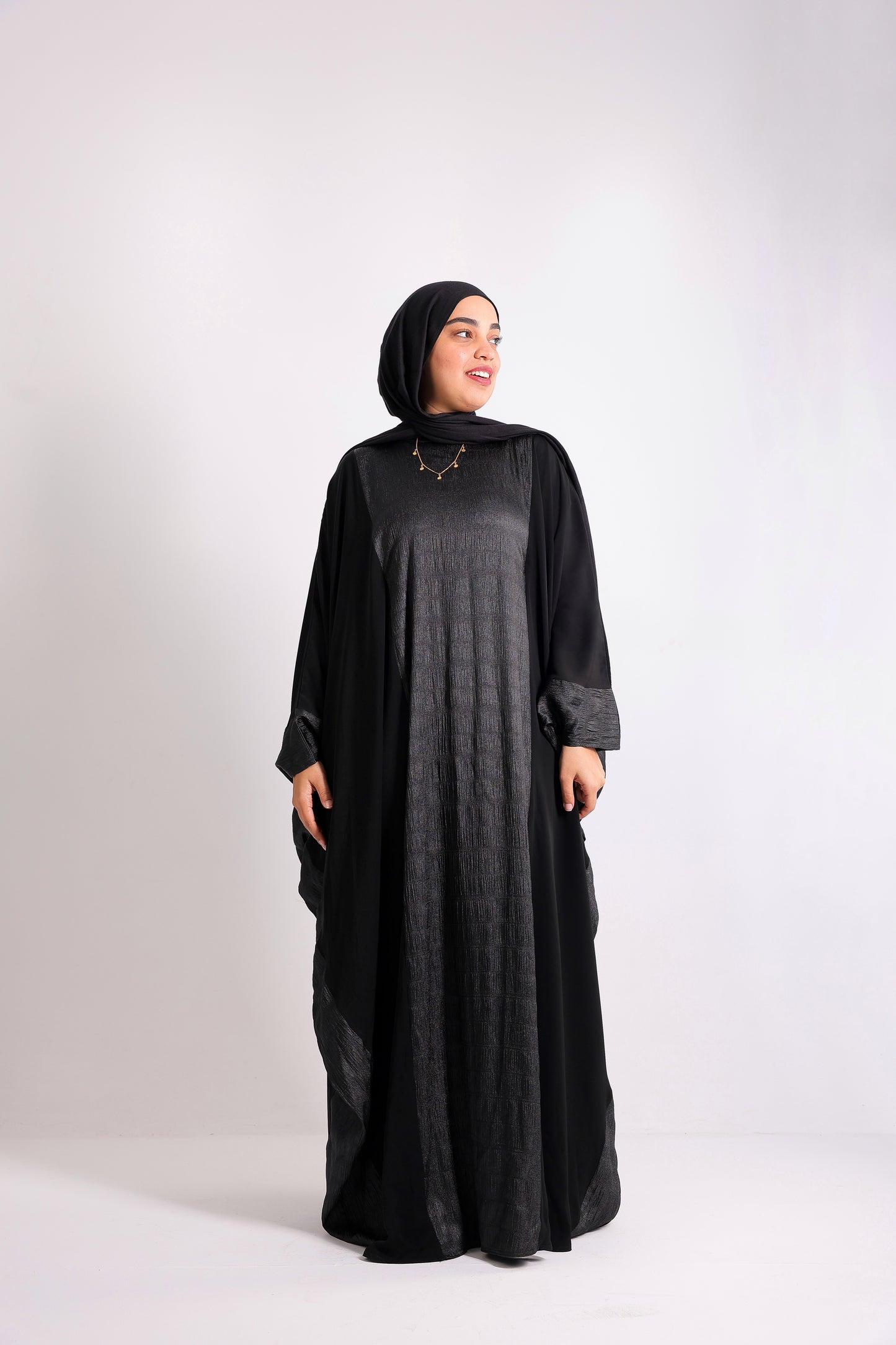 A luxurious silk abaya with embroidered silk accents, designed with an inner belt Code 405