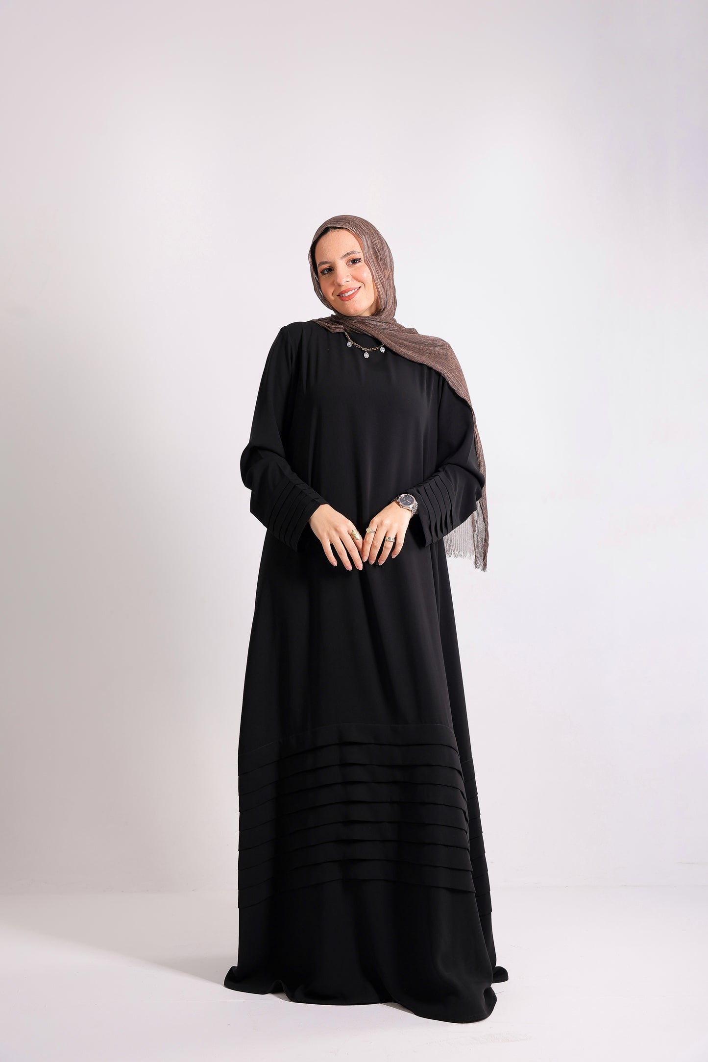 Soft crepe abaya with elegant pleated details on the sleeves and hem.Code 508