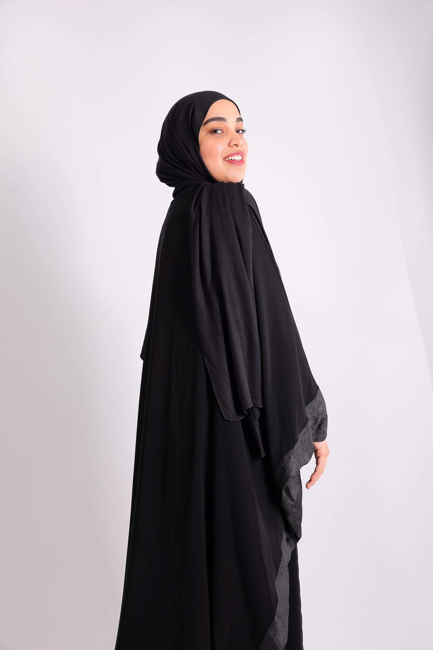 A luxurious silk abaya with embroidered silk accents, designed with an inner belt Code 405