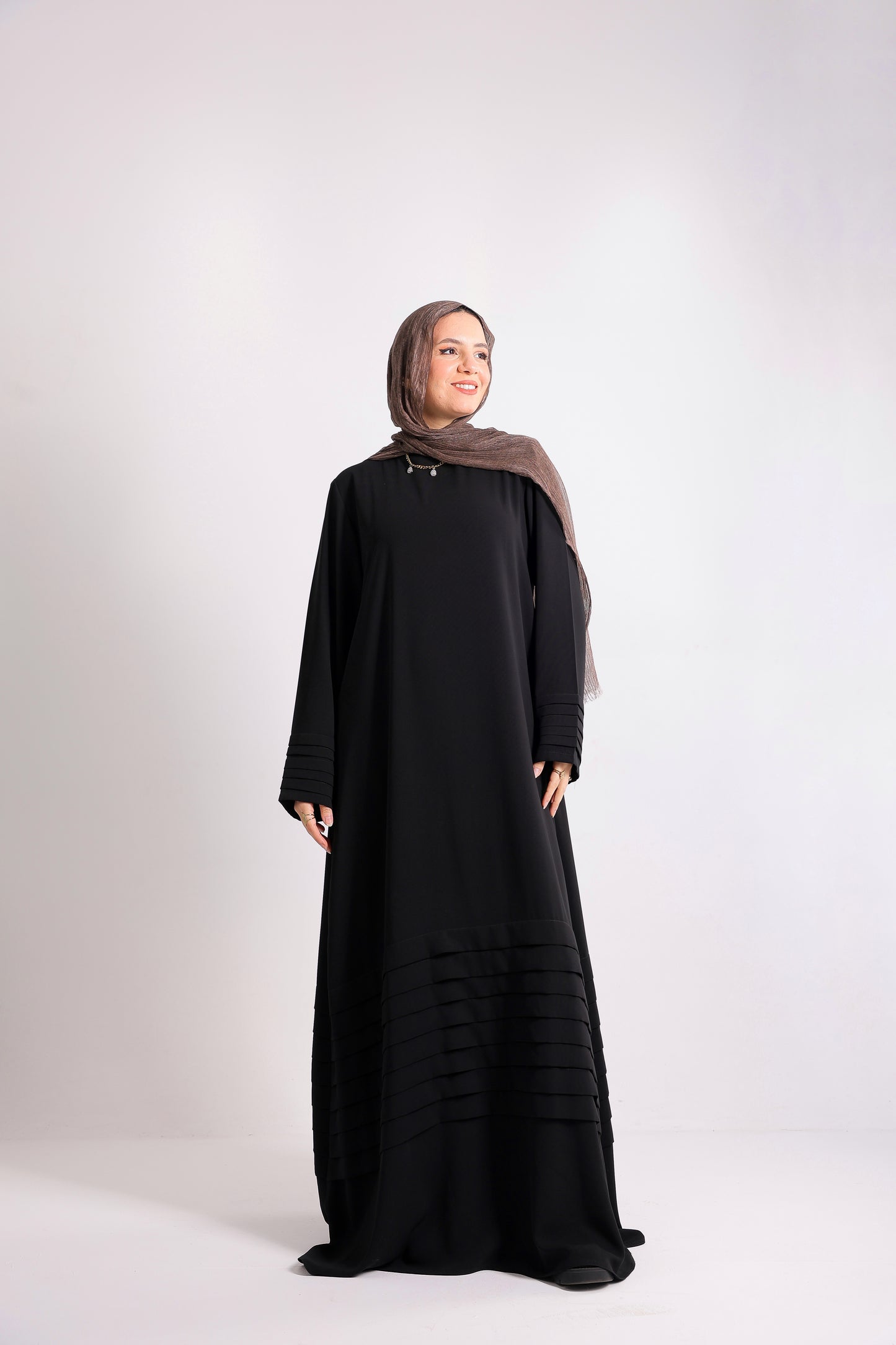 Soft crepe abaya with elegant pleated details on the sleeves and hem.Code 508