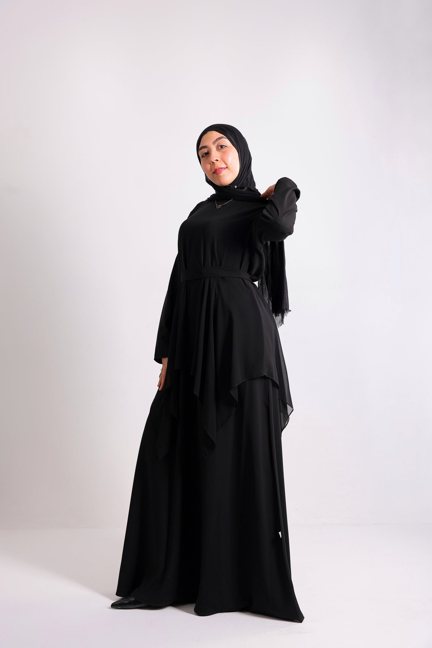 Lily crepe abaya is designed with delicate chiffon ruffles and a matching belt code 112 B