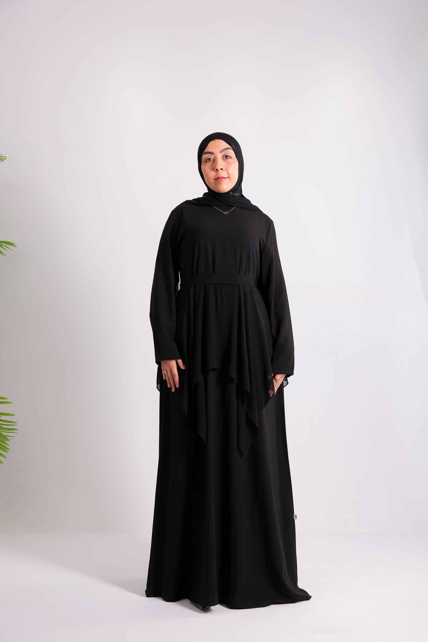 Lily crepe abaya is designed with delicate chiffon ruffles and a matching belt code 112 B