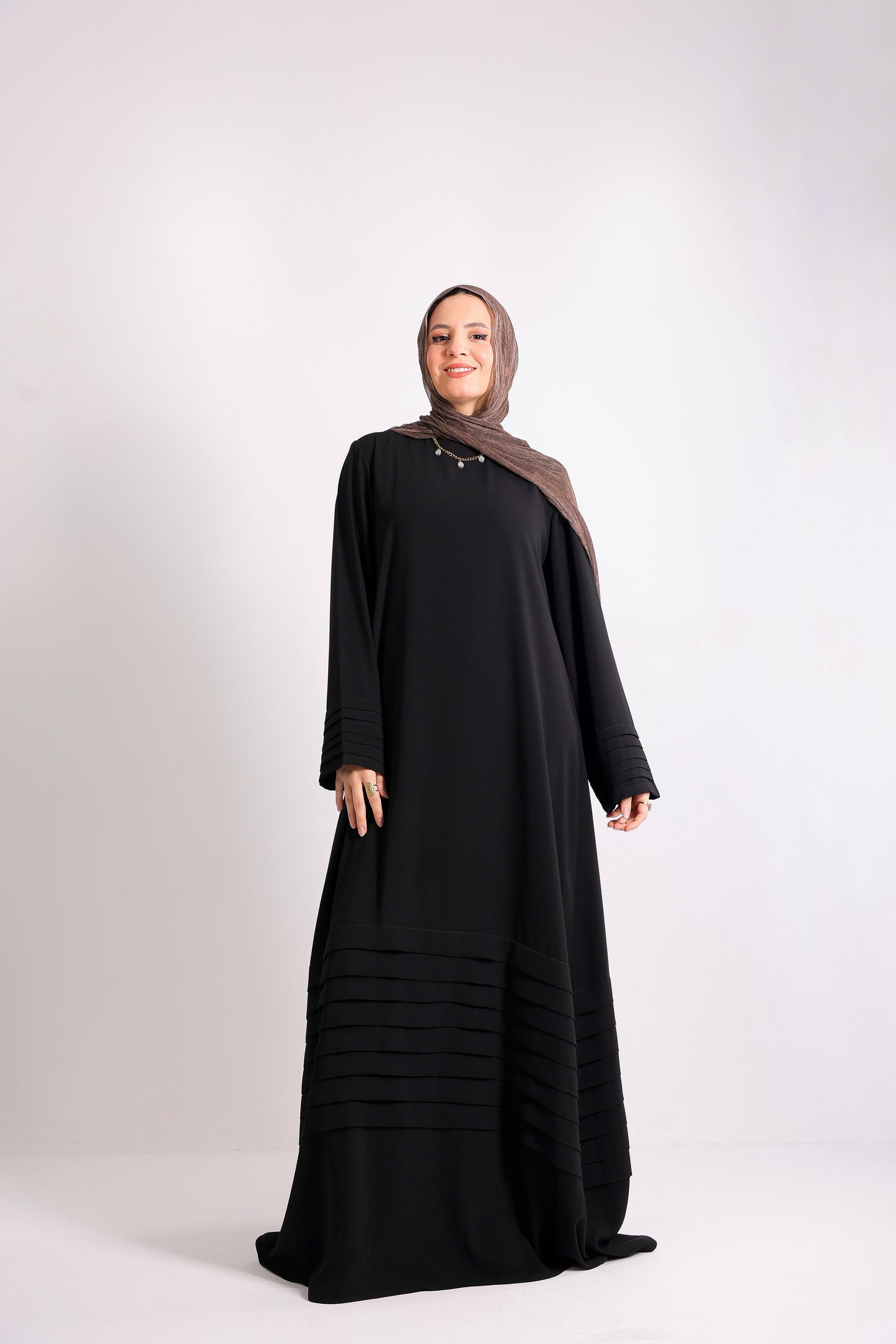 Soft crepe abaya with elegant pleated details on the sleeves and hem.Code 508